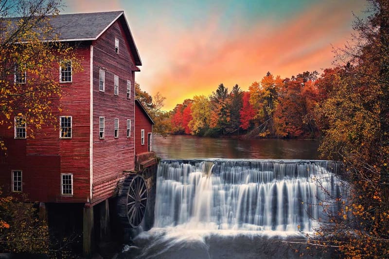 An historic Wisconsin mill and waterfall in autumn, in the Dodge County area